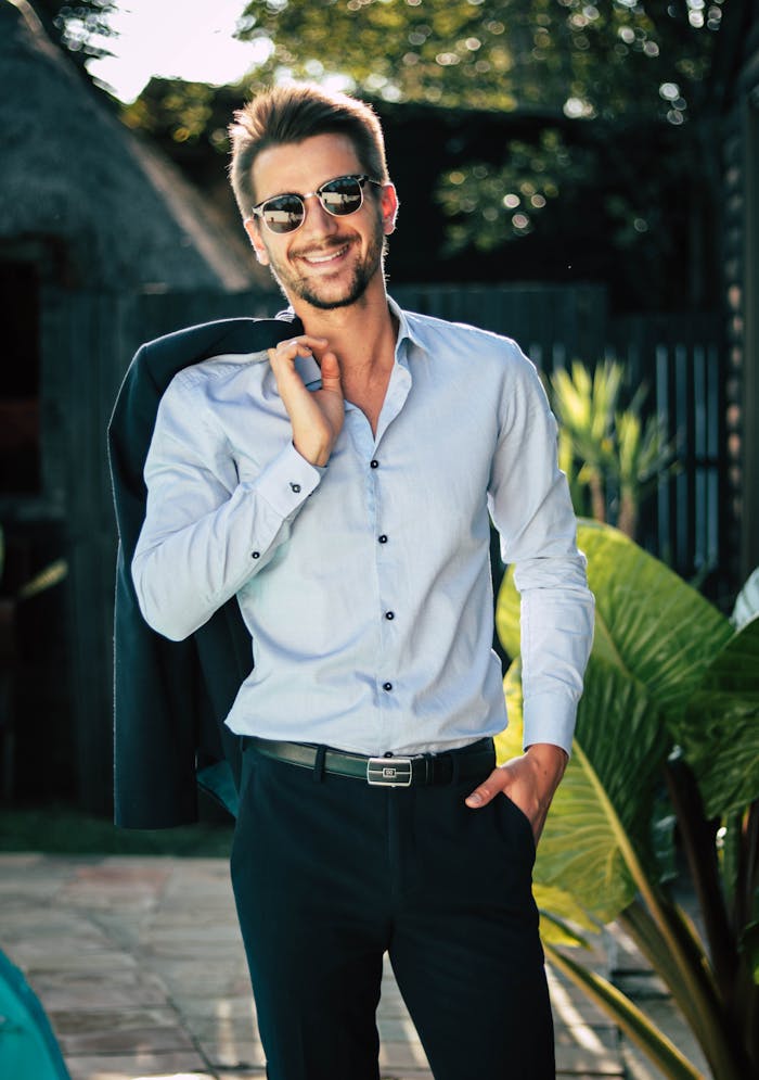 about-01 Confident young man in a stylish suit outdoors, exuding charm and elegance.