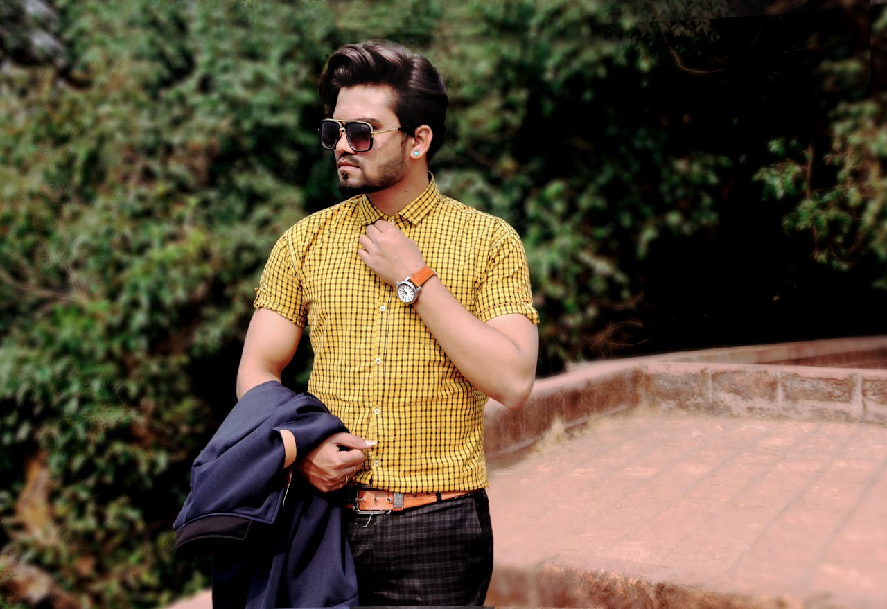 hero-img-01 Stylish man wearing sunglasses and checkered shirt posing outdoors in Mahabaleshwar.