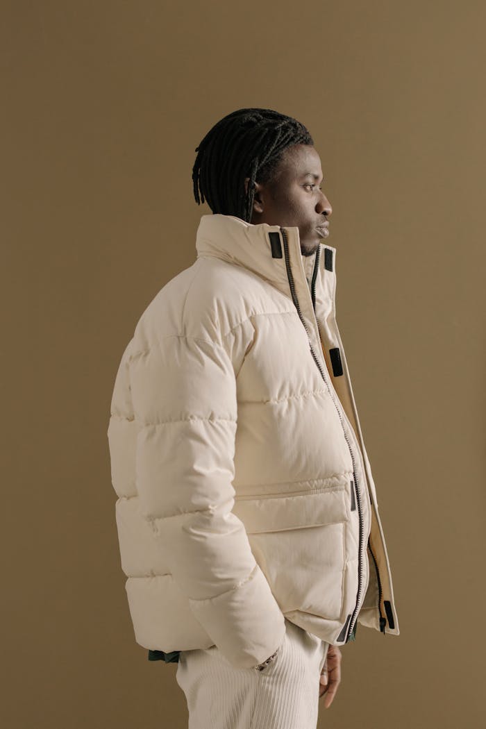 gallery-6 Profile portrait of a stylish man in a winter coat, beige background
